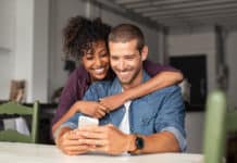 Tinder Not Working? Try These 15 Fixes! couple using phone